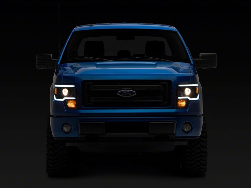 Raxiom 09-14 Ford F-150 Axial Series Projector Headlights w/ LED Light Bar- Blk Housing (Clear Lens)