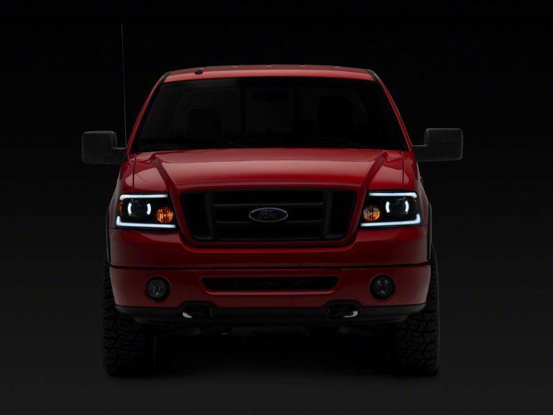 Raxiom 04-08 Ford F-150 Axial Series Projector Headlights w/ SEQL LED Bar- Blk Housing (Clear Lens)