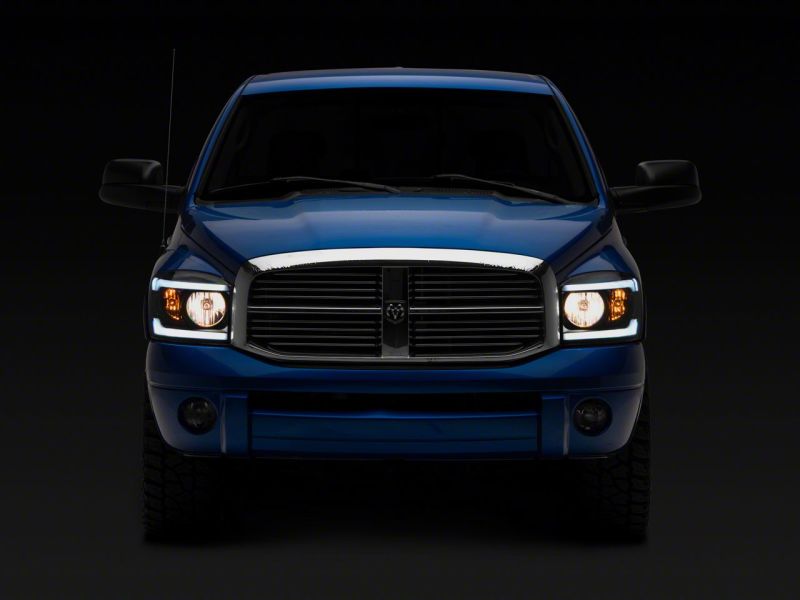 Raxiom 06-09 Dodge RAM 1500/2500/3500 Axial Headlights w/ SEQL LED Bar- Blk Housing (Clear Lens)