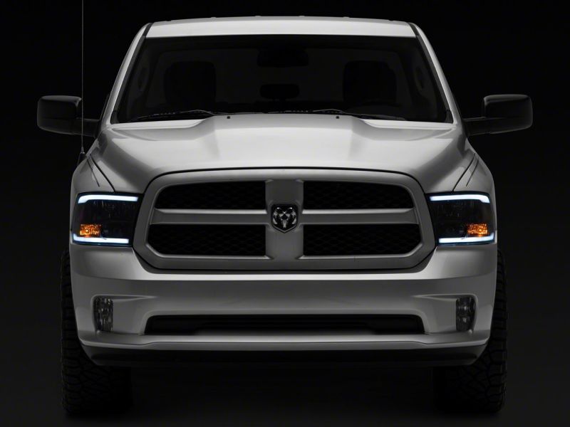 Raxiom 09-18 Dodge RAM 1500/2500/3500 Axial Headlights w/ SEQL LED Bar- Blk Housing (Clear Lens)